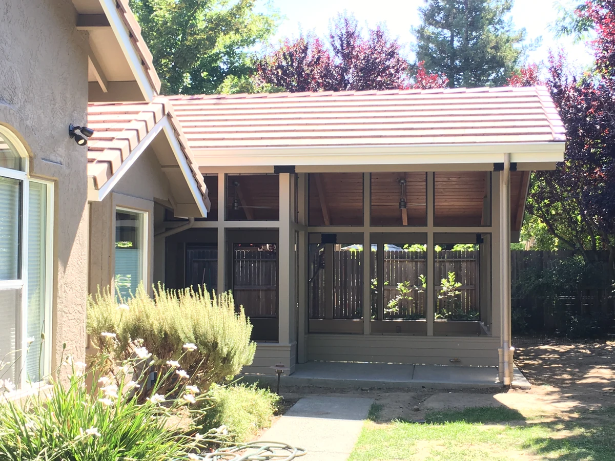 Exterior of a sunroom home addition with a tile roof matched to the existing house, Placer County